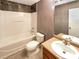 Bathroom with shower-tub combo, single sink, and neutral tile at 10312 Hugue Way, Charlotte, NC 28214