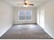 Bedroom features a ceiling fan, closet, and a window for natural light at 10312 Hugue Way, Charlotte, NC 28214