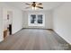 Bedroom with neutral carpet, ceiling fan, and large window showing neighborhood view at 10312 Hugue Way, Charlotte, NC 28214