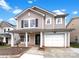 Charming two-story home featuring a covered front porch and attached one car garage at 10312 Hugue Way, Charlotte, NC 28214