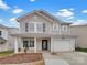 Charming two-story home featuring a covered front porch and attached one car garage at 10312 Hugue Way, Charlotte, NC 28214