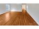 Living room with hardwood floors, white walls, and a large window at 10312 Hugue Way, Charlotte, NC 28214