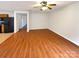 Open-concept living room featuring hardwood floors and access to kitchen appliances at 10312 Hugue Way, Charlotte, NC 28214