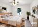 Staged bedroom with soft carpet, ceiling fan, and natural light at 10312 Hugue Way, Charlotte, NC 28214