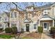 Charming townhouse featuring a black door adorned with a wreath and a well-manicured front yard at 10438 Trolley Run Dr, Cornelius, NC 28031