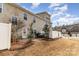 Townhouse backyard featuring a small patio with outdoor seating and well-kept landscaping at 105 Burlingame Ct # B, Mooresville, NC 28117