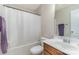 Well-lit bathroom with a shower curtain, a large mirror, and a sink with a wood cabinet at 105 Burlingame Ct # B, Mooresville, NC 28117