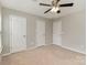 Bright bedroom features two closets, carpet, and a ceiling fan at 105 Burlingame Ct # B, Mooresville, NC 28117