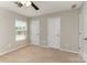 Neutral bedroom featuring two closets, carpet, and a window with natural light at 105 Burlingame Ct # B, Mooresville, NC 28117