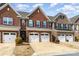 Attractive brick townhome with a two-car garage and manicured front yard at 105 Burlingame Ct # B, Mooresville, NC 28117
