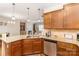 Eat-in kitchen featuring granite countertops, stainless steel appliances, and dark wood cabinets at 105 Burlingame Ct # B, Mooresville, NC 28117