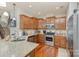 Well-equipped kitchen with stainless steel appliances, granite countertops, and wooden cabinets at 105 Burlingame Ct # B, Mooresville, NC 28117