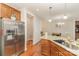 Spacious eat-in kitchen with stainless steel refrigerator, granite countertops, and hardwood floors at 105 Burlingame Ct # B, Mooresville, NC 28117