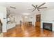 Open concept living room with hardwood floors, fireplace, and ceiling fan at 105 Burlingame Ct # B, Mooresville, NC 28117