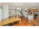 Open-concept layout with hardwood floors seamlessly connecting the dining, kitchen, and living areas at 105 Burlingame Ct # B, Mooresville, NC 28117