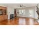 Cozy living room featuring a fireplace, built-in shelving, and hardwood floors at 105 Burlingame Ct # B, Mooresville, NC 28117