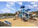 View of community playground with slides and climbing structure on woodchip ground at 105 Burlingame Ct # B, Mooresville, NC 28117