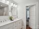 Bright bathroom featuring a double vanity, marble countertop, and access to an adjacent room at 1105 Vanizer St, Charlotte, NC 28208