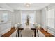Bright dining room with a table for six and lots of natural light from the large window at 1105 Vanizer St, Charlotte, NC 28208
