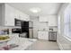 Modern kitchen with white cabinets, stainless steel appliances, and bright, natural lighting at 1105 Vanizer St, Charlotte, NC 28208