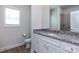Bathroom features a granite countertop, a single sink, and a framed mirror at 111 Tradesmen Trl # 75, Troutman, NC 28166