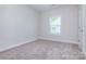 An empty bedroom offers natural light, neutral walls, and plush carpeting at 111 Tradesmen Trl # 75, Troutman, NC 28166