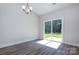 Dining room features modern lighting, sliding doors to the backyard, and wood-look flooring at 111 Tradesmen Trl # 75, Troutman, NC 28166