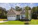 Charming single-story home featuring a two-car garage, stone accents, and a well-manicured lawn at 111 Tradesmen Trl # 75, Troutman, NC 28166