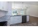Modern kitchen features stainless steel appliances, granite countertops, and opens to the living area at 111 Tradesmen Trl # 75, Troutman, NC 28166