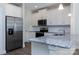 Modern kitchen with stainless steel appliances, granite countertops, and white cabinets at 111 Tradesmen Trl # 75, Troutman, NC 28166