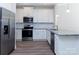 Modern kitchen with stainless steel appliances, granite countertops, and white cabinets at 111 Tradesmen Trl # 75, Troutman, NC 28166