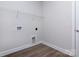 A functional laundry room space with overhead shelving and hookups ready for appliances at 111 Tradesmen Trl # 75, Troutman, NC 28166