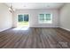 Bright living room featuring wood-look floors, sliding glass doors and a large window at 111 Tradesmen Trl # 75, Troutman, NC 28166