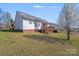 Exterior backyard view of home with deck and blooming tree at 1232 Pressley Downs Se Dr, Concord, NC 28025