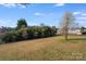 Grassy backyard featuring beautiful blooming trees at 1232 Pressley Downs Se Dr, Concord, NC 28025