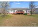 Exterior backyard view of home with deck and blooming trees at 1232 Pressley Downs Se Dr, Concord, NC 28025