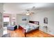 Serene bedroom with hardwood floors, a ceiling fan, and natural light from the bay window at 1232 Pressley Downs Se Dr, Concord, NC 28025