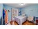 Light-filled bedroom featuring a cozy bed, chair and calming blue walls at 1232 Pressley Downs Se Dr, Concord, NC 28025