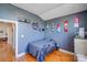 This bedroom has hardwood floors, blue walls, and an interesting layout at 1232 Pressley Downs Se Dr, Concord, NC 28025