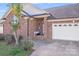 Inviting brick home with covered front porch, well-kept lawn, and attached two-car garage at 1232 Pressley Downs Se Dr, Concord, NC 28025