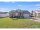Charming brick home with a manicured lawn, two-car garage, and lush landscaping on a sunny day at 1232 Pressley Downs Se Dr, Concord, NC 28025