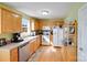 Well-lit kitchen with wood floors, cabinets, stainless steel appliances, and ample counter space at 1232 Pressley Downs Se Dr, Concord, NC 28025