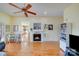 Open-concept living room featuring a fireplace, hardwood floors, and views into the kitchen at 1232 Pressley Downs Se Dr, Concord, NC 28025