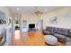 Cozy living room with large windows, hardwood floors, and comfortable seating area at 1232 Pressley Downs Se Dr, Concord, NC 28025