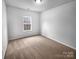 A bright bedroom featuring a large window and plush carpeting at 12332 Flatbush Dr, Huntersville, NC 28078