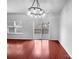 Dining area with hardwood floors, a modern chandelier, and access to the deck at 12332 Flatbush Dr, Huntersville, NC 28078