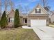 Charming brick home featuring a two-car garage, and lovely, mature landscaping at 12332 Flatbush Dr, Huntersville, NC 28078
