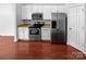 Kitchen featuring stainless steel appliances, white cabinetry, and hardwood floors at 12332 Flatbush Dr, Huntersville, NC 28078