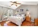 Comfortable bedroom with a vaulted ceiling, ceiling fan, and natural light from a large window at 12421 Poplar Forest Dr, Charlotte, NC 28278