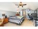 This bedroom includes gray walls, an overhead fan and lights, and desk space at 12421 Poplar Forest Dr, Charlotte, NC 28278